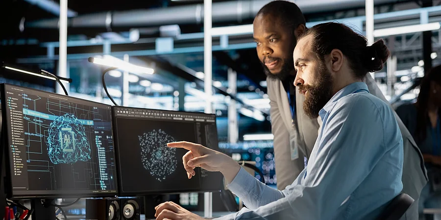 Service desk engineers reviewing live support dashboards together