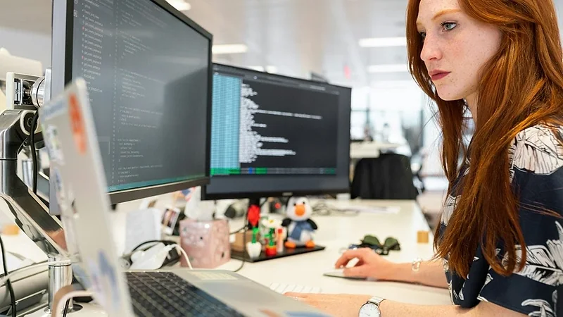 Engineer working at a desk alongside a client team
